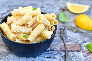  Italian home made  rigatoni   pasta  with  tuna  fish, parmesan cheese and black pepper .