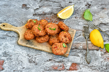 Home made  oven baked  mini meatballs  from  chicken and vegetable on  wooden background