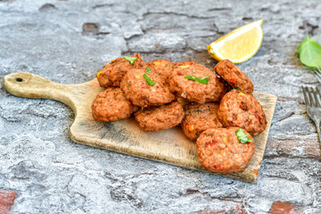 Home made  oven baked  mini meatballs  from  chicken and vegetable on  wooden background