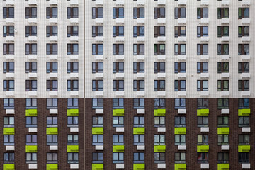 Background image - white and brown wall of a multi-storey building with windows