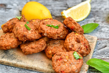 Home made  oven baked  mini meatballs  from  chicken and vegetable on  wooden background