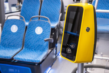 comfortable city bus, an electric bus or a hydrogen bus cabin with payment for travel via validator - 480897456
