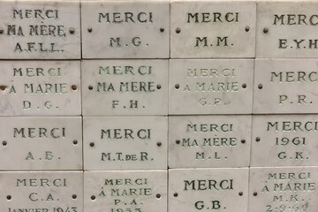 Plaques of thanksgiving to the Virgin Mary on a wall around the Church of the Miraculous Medal in Paris
