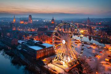 Beautiful sunset over the Gdansk city with illuminated ferris wheel, Poland