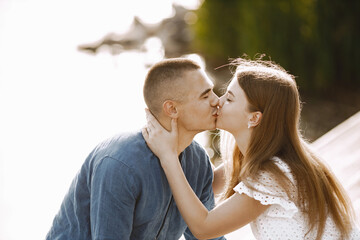 Portrait of a romantic couple kissing near the lake