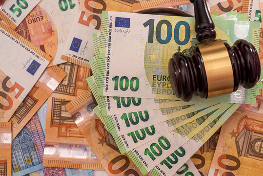 new pure  euro banknotes are laid out and on them a powerful wooden judge's gavel