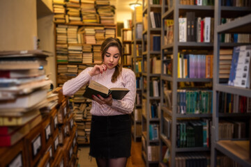 young student after graduation comes to the library to learn new knowledge.