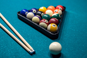 Billiard cue and colour balls on snooker table while game - obrazy, fototapety, plakaty
