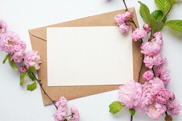 card invitation in envelope with pink spring flowers. sakura. almond flowers