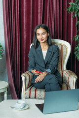 young Asian girl business style clothes, with a laptop