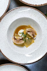 Dumplings, dumplings, with egg and decorated with champignons, dill.