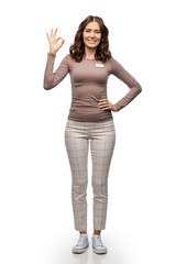 Obraz premium sale, shopping and business concept - happy female shop assistant or saleswoman with name tag showing ok gesture over white background