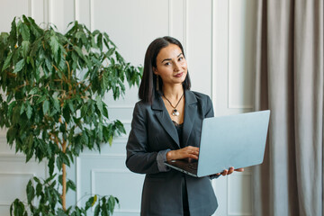 young Asian girl business style clothes, with a laptop