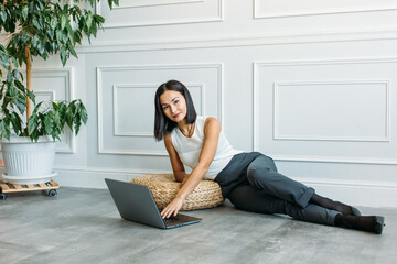 young Asian girl business style clothes, with a laptop