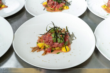 Tartarus from young calf with avocado, garnished with nori leaves and parsley.