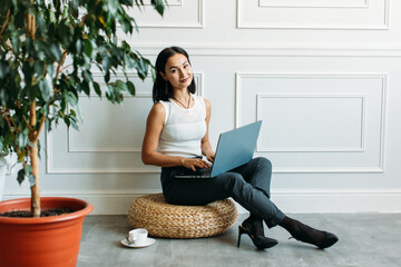 young Asian girl business style clothes, with a laptop