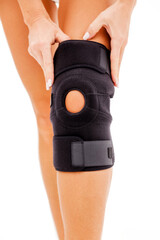 Knee injury. Girl holds hands bandage on his leg.