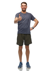 Fototapeta premium fitness, sport and healthy lifestyle concept - smiling man in sports clothes with smart watch or tracker showing thumbs up over white background
