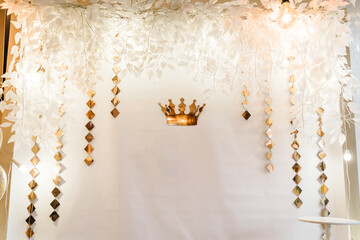 Decor with white and gold arch, wall for birthday party. Decorations for the birthday with a crown...