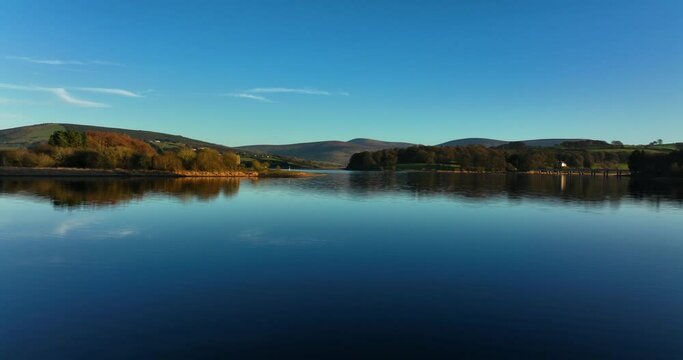 Blessington Lakes, Wicklow, Ireland. January 2022 Drone pushes east while gradually ascending above the Poulaphouca reservoir with Carrig and Lackan in the distance.