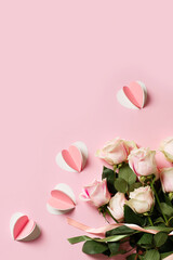 Flat lay with roses on pink background, valentines day and mothers day concept