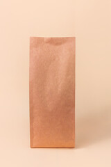 Sachet pouch bag mockup neutral beige background monochrome. Merchandise packaging. Blank brown...
