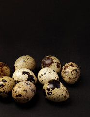 Obraz premium Quail eggs on black background. Healthy food concept. Selective focus
