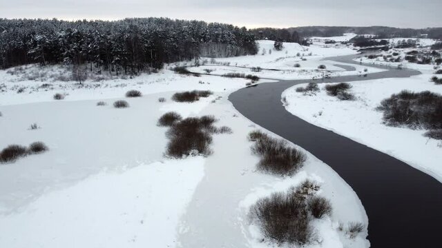 flying a drone over a winter river river. panorama of the winter landscape. pushkin mountains, Mikhailovskoye. 