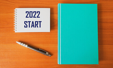 Notepad with text 2022 start. The concept of two thousand twenty-second year. New year - new opportunities and goals