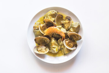 Artichokes with clams and prawns, typical traditional Spanish food for Christmas and New Year