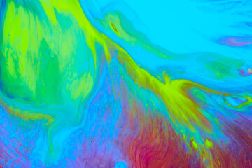 Bright creative texture made by floating paints. Macro photography of flowing inks