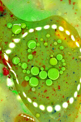 Vertical image. Background and air bubbles in green.