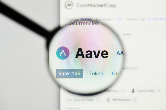 Milan, Italy - January 11, 2022: aave - AAVE website's hp.  aave, AAVE coin logo visible through a loope. Defi, ntf, cryptocurrency concepts illustrative editorial.