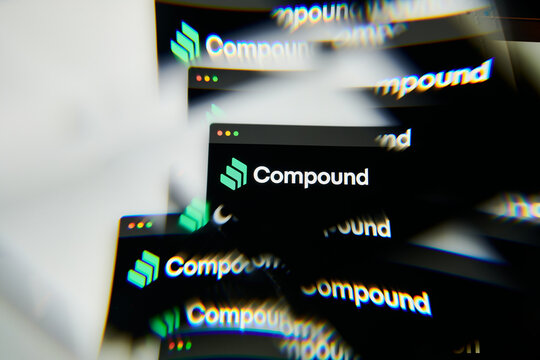 Milan, Italy - January 11, 2022: compound - COMP logo on laptop screen seen through an optical prism. Dynamic and unique image form compound, COMP coin website. Illustrative editorial.