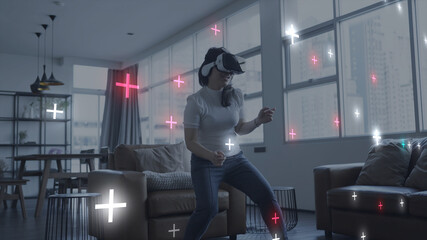 Woman playing VR virtual reality virtual event exercise game competition metaverse digital world...