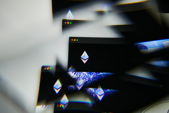 Milan, Italy - January 11, 2022: Etherum - ETH logo on laptop screen seen through an optical prism. Dynamic and unique image form Etherum, ETH coin website. Illustrative editorial.