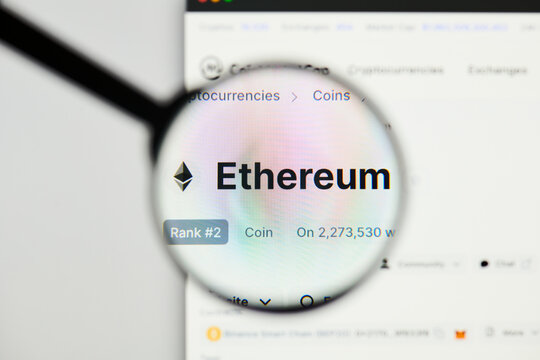 Milan, Italy - January 11, 2022: Etherum - ETH website's hp.  Etherum, ETH coin logo visible through a loope. Defi, ntf, cryptocurrency concepts illustrative editorial.