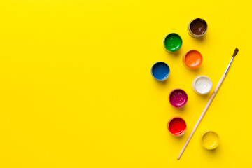 art palette with paint and brushes, close up. Top view with empty space. workplace for creativity. home teaching concept drawing