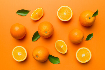 Fruit pattern of fresh orange slices on colored background. Top view. Copy Space. creative summer concept. Half of citrus in minimal flat lay