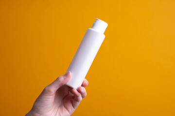 packaging of lotion or hand cream in female hands