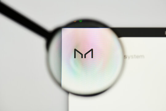 Milan, Italy - January 11, 2022: maker - MKR website's hp.  maker, MKR coin logo visible through a loope. Defi, ntf, cryptocurrency concepts illustrative editorial.
