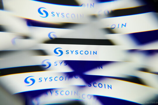 Milan, Italy - January 11, 2022: syscoin - SYS logo on laptop screen seen through an optical prism. Dynamic and unique image form syscoin, SYS coin website. Illustrative editorial.