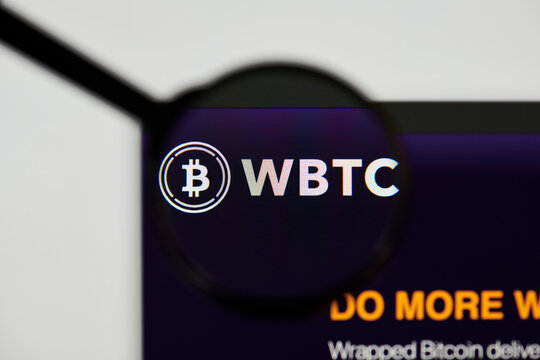 Milan, Italy - January 11, 2022: wrapped bitcoin - WBTC website's hp.  wrapped bitcoin, WBTC coin logo visible through a loope. Defi, ntf, cryptocurrency concepts illustrative editorial.