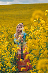 Fototapeta premium sexy woman in the field with a guitar. concept freedom, inspiration, relaxation.