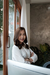 Portrait of entrepreneur young asian woman, business woman arms crossed on modern office