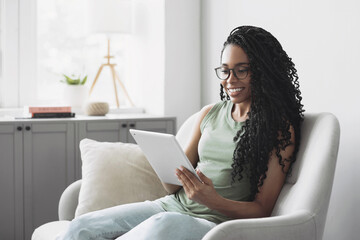 Young smiling woman using digital tablet computer at home, Leisure, relaxation, online learning, web chat, video call, freelance, modern lifestyle concept