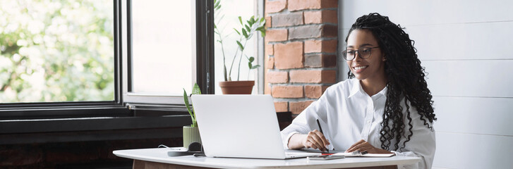 Young woman using laptop computer at office panoramic banner. Student girl working at home. Work or study from home, freelance, business, lifestyle concept - obrazy, fototapety, plakaty