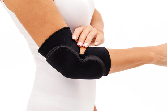 A Woman Wearing Elbow Brace Over White Background