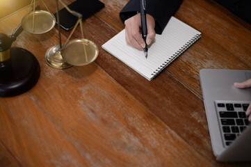 DeskJudge gavel with Justice lawyers having team meeting at law firm in background. Concepts of law