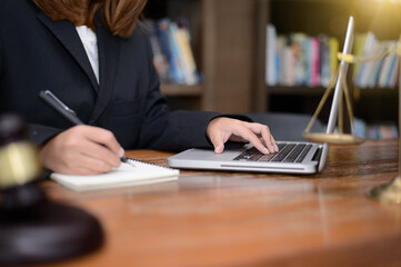 DeskJudge gavel with Justice lawyers having team meeting at law firm in background. Concepts of law